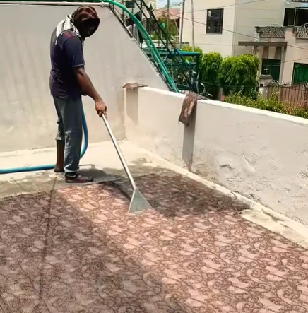 Rooftop carpet cleaning by UrbanFix technician in Multan